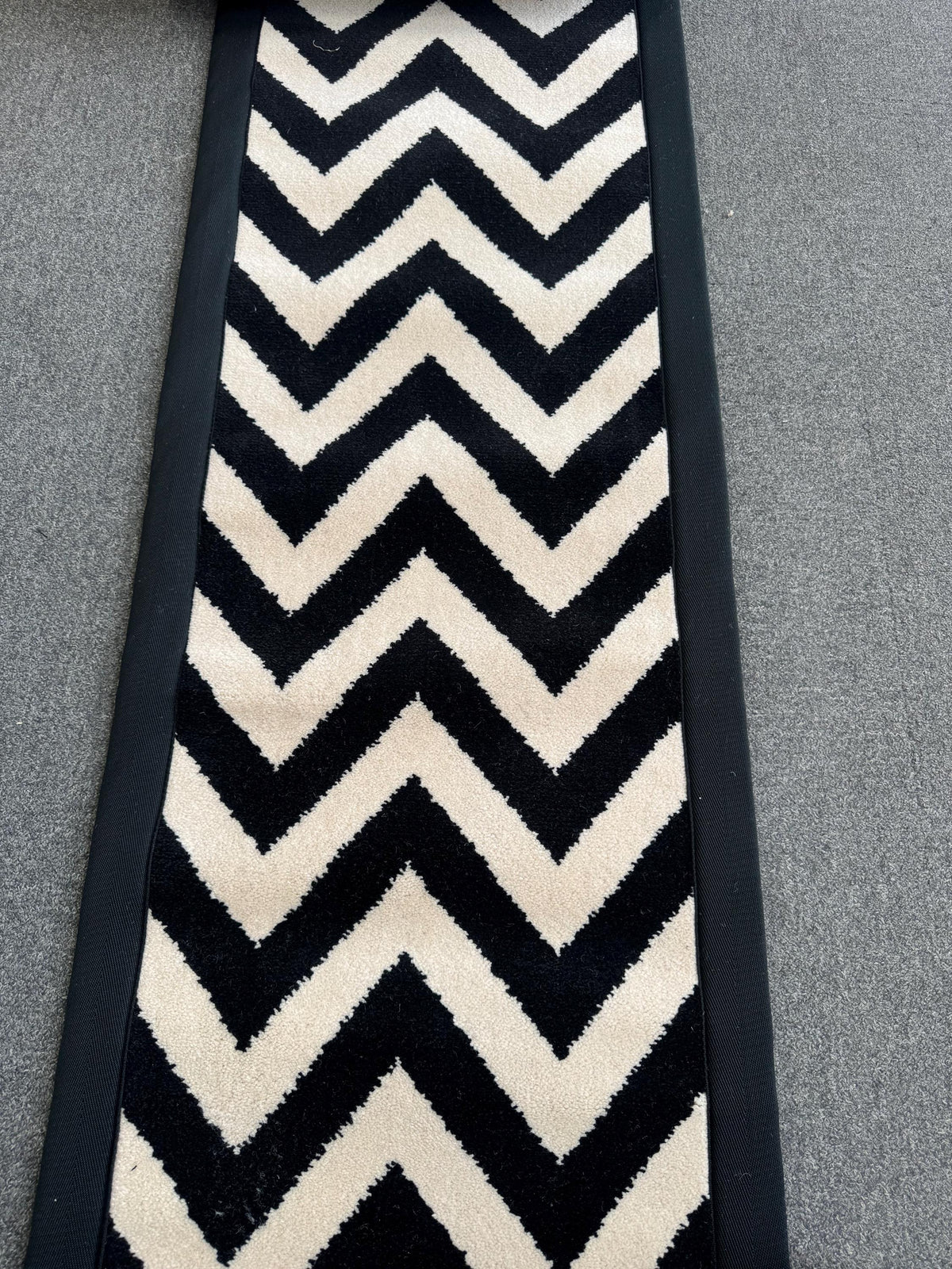 Axminster Black and white stitched taped edge