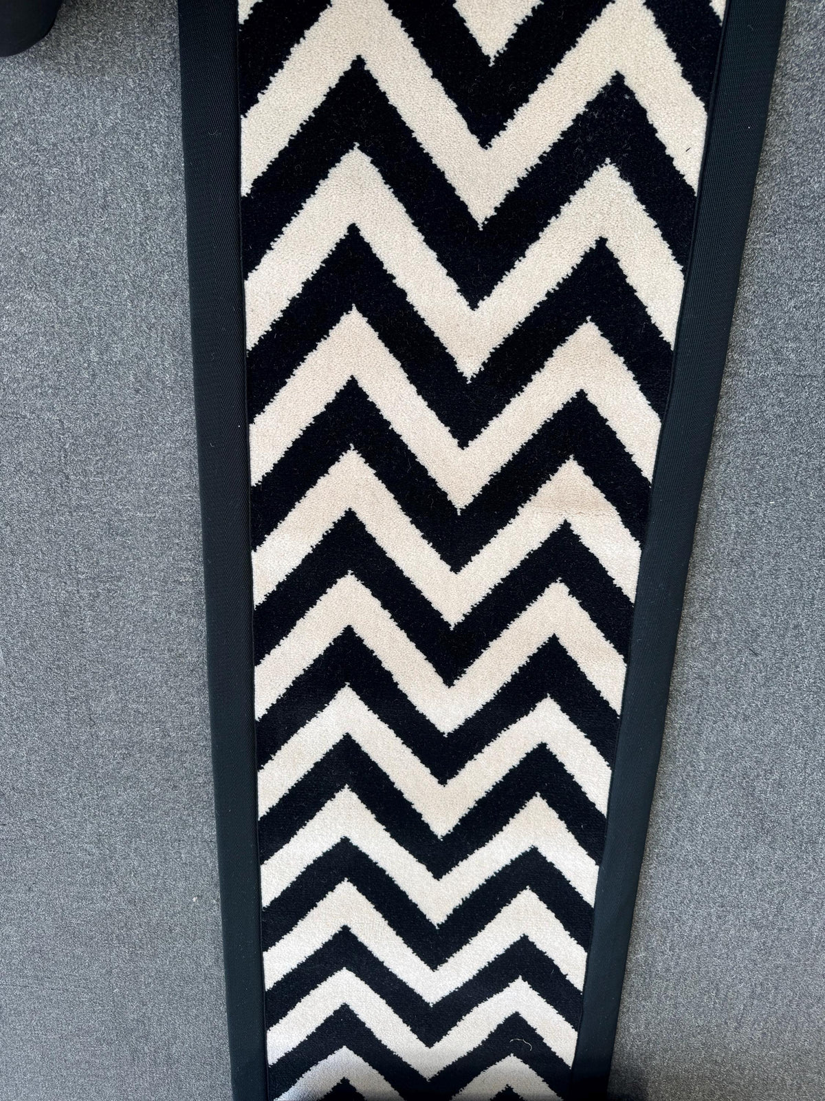 Axminster Black and white stitched taped edge