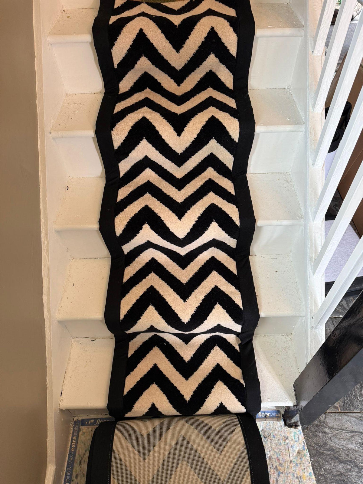 Axminster Black and white stitched taped edge