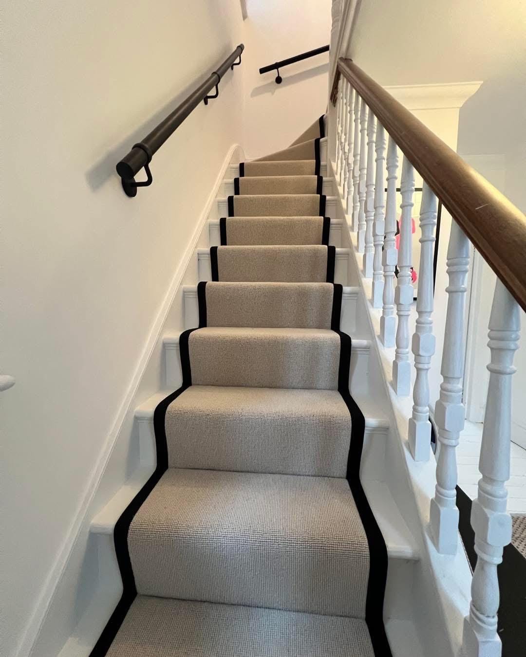 Beige Berber stair runner with black stitched taped edge