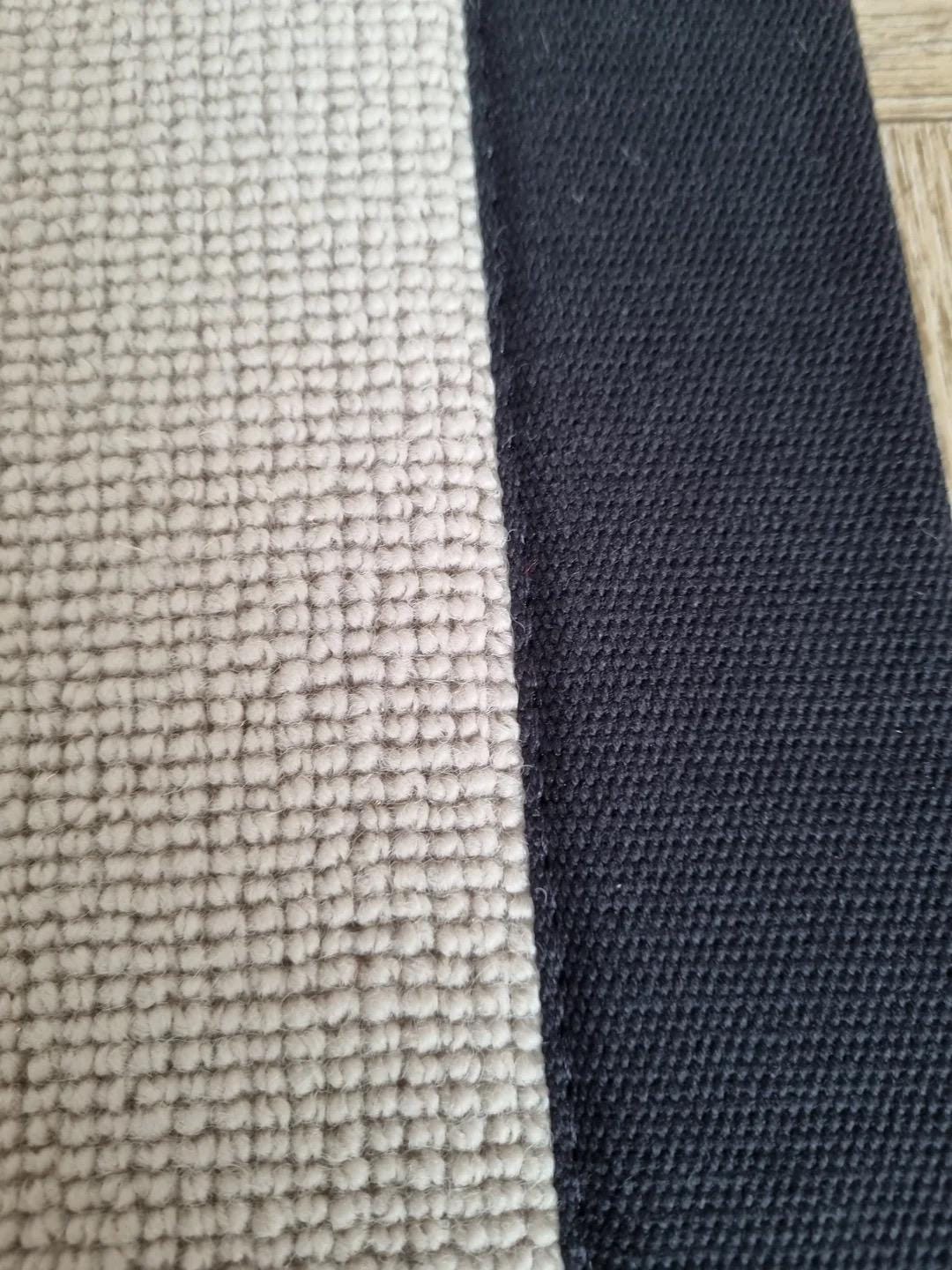 Beige Berber stair runner with black stitched taped edge
