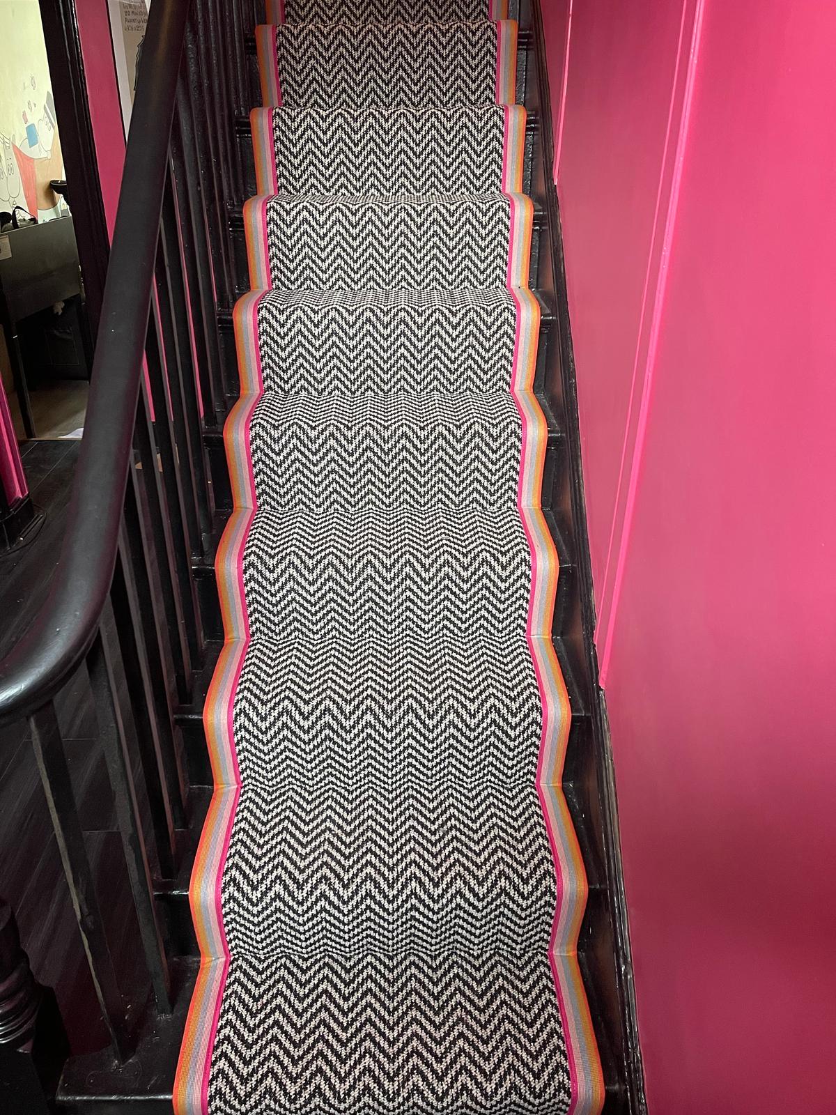 Black and white chevron multi coloured taped edge stair runner
