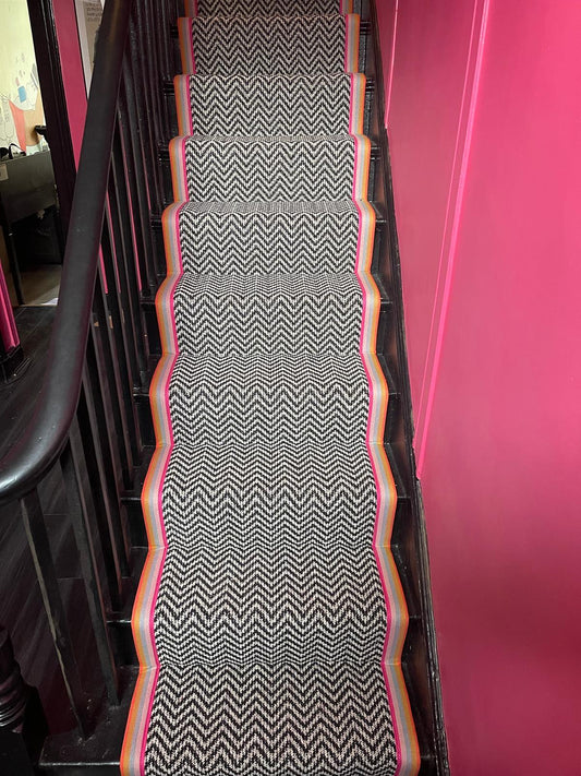 Black and white chevron multi coloured taped edge stair runner