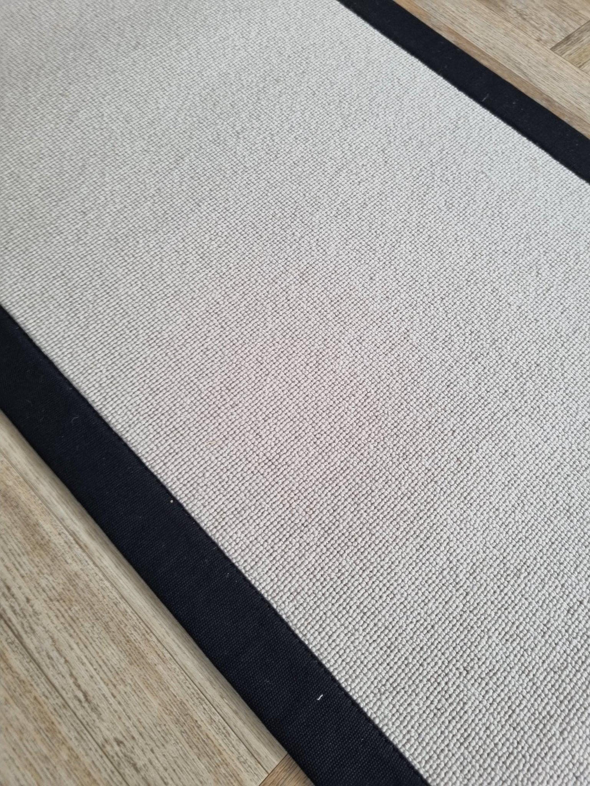 Grey Berber stair runner with stitched black taped edge