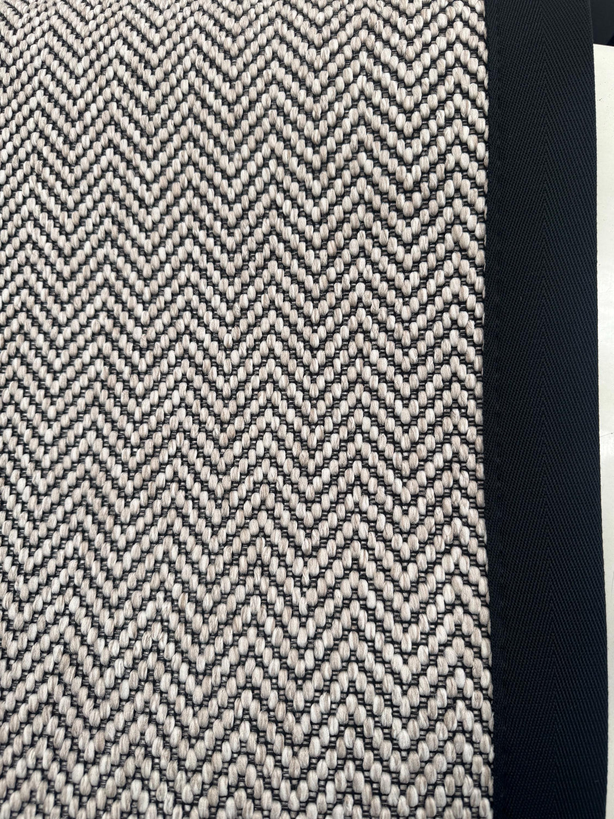Ivory woven berber black stitched taped edge stair runner
