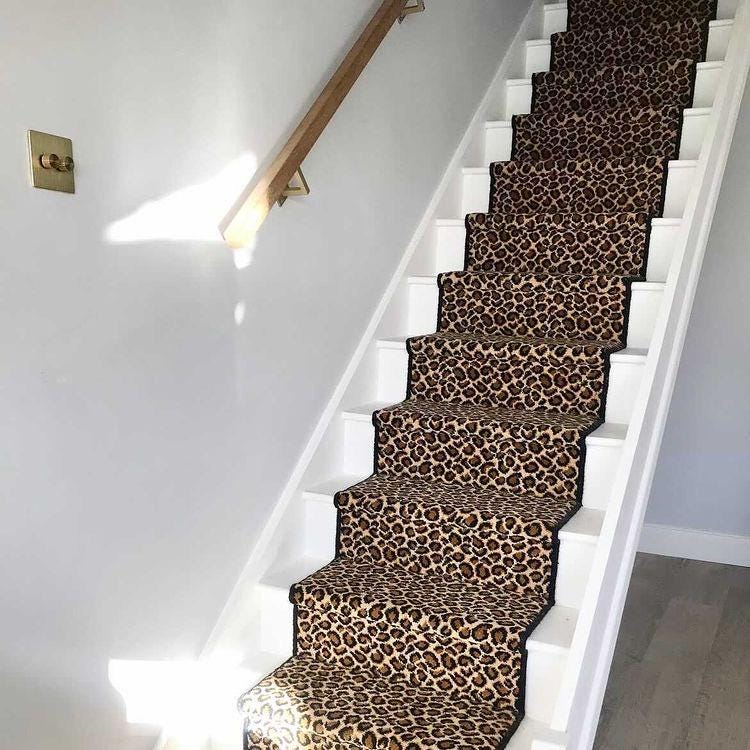 Leopard Wilton stair runner with black whipped edge