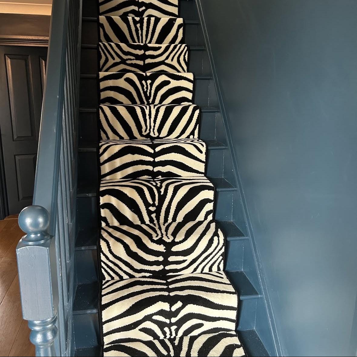 Zebra Wilton stair runner with black whipped edge